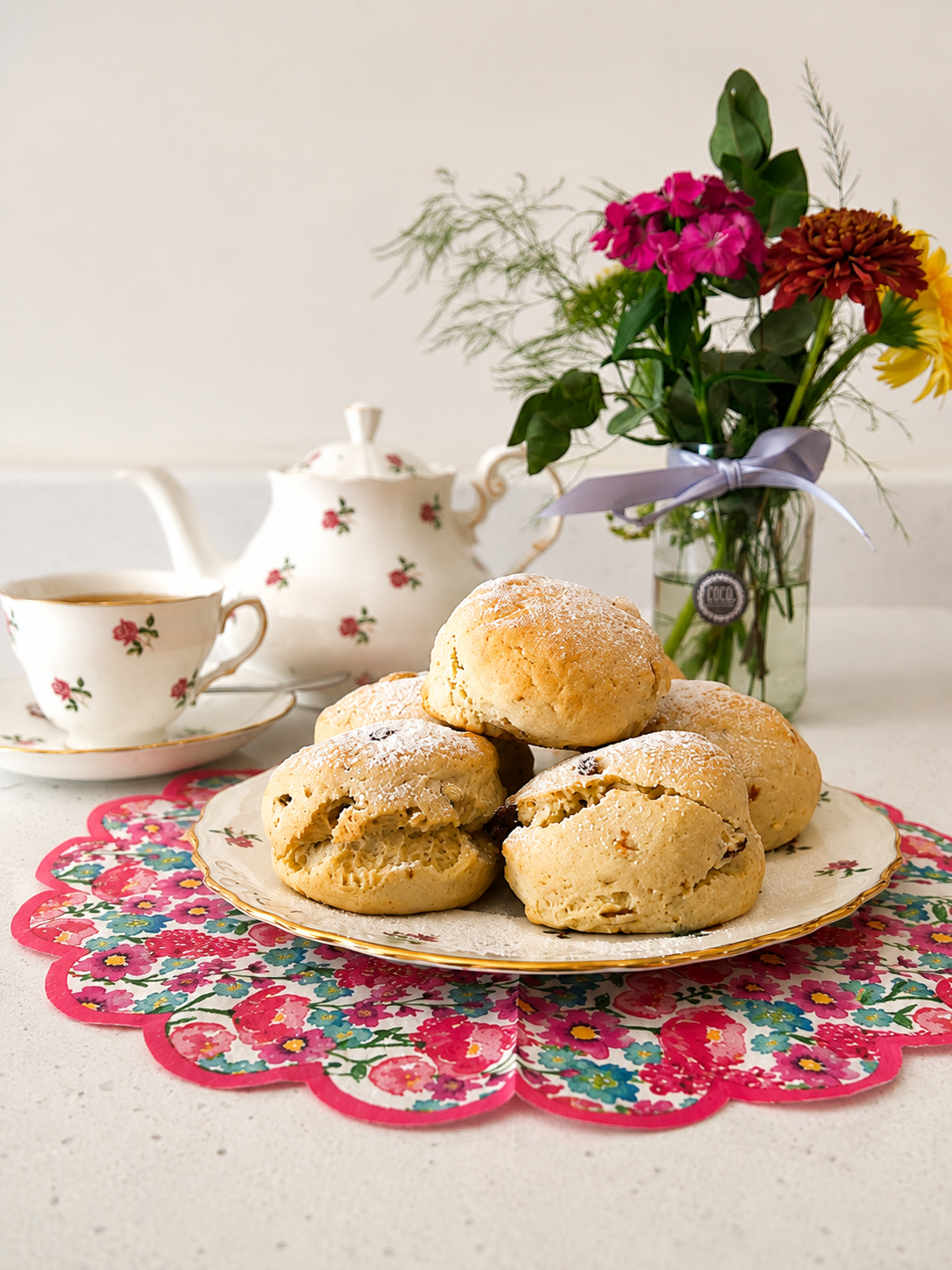 Fresh scones served with a floral teapot and teacups at The Tea Cosy