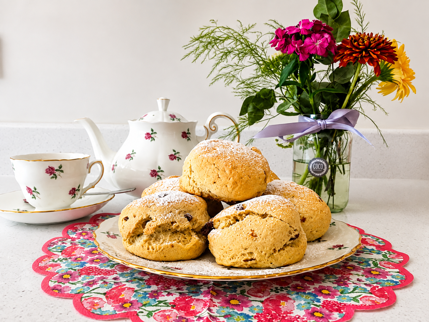 Fresh scones with a floral tea set at The Tea Cosy